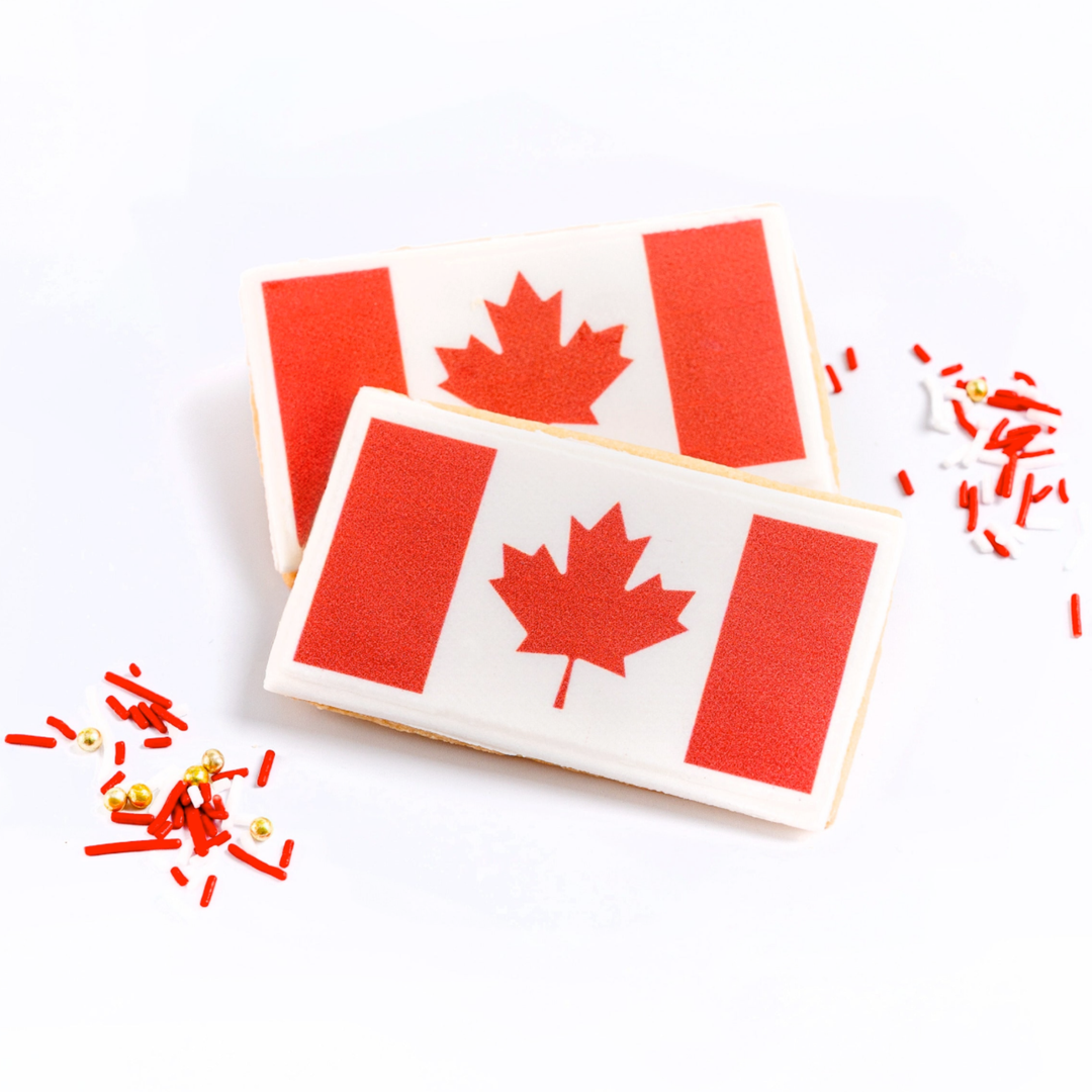 Two cookies with a Canadian flag design on a white background