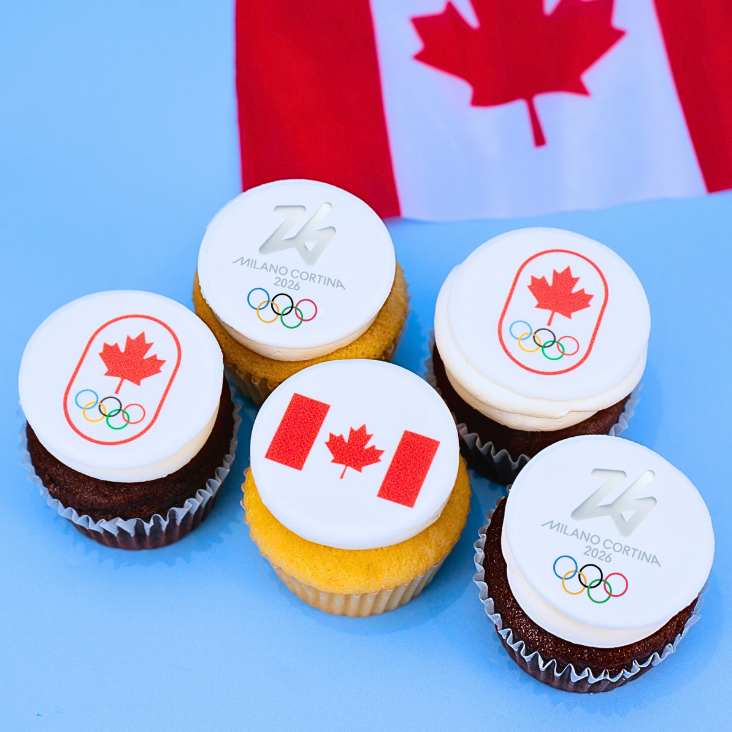 Cupcakes with Olympic and Canadian flag designs on a blue background with a Canadian flag.