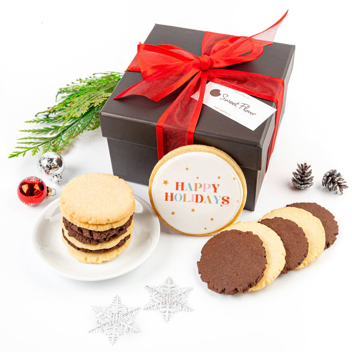 Gift box with a red ribbon, cookies, and a 'Happy Holidays' cookie on a white background