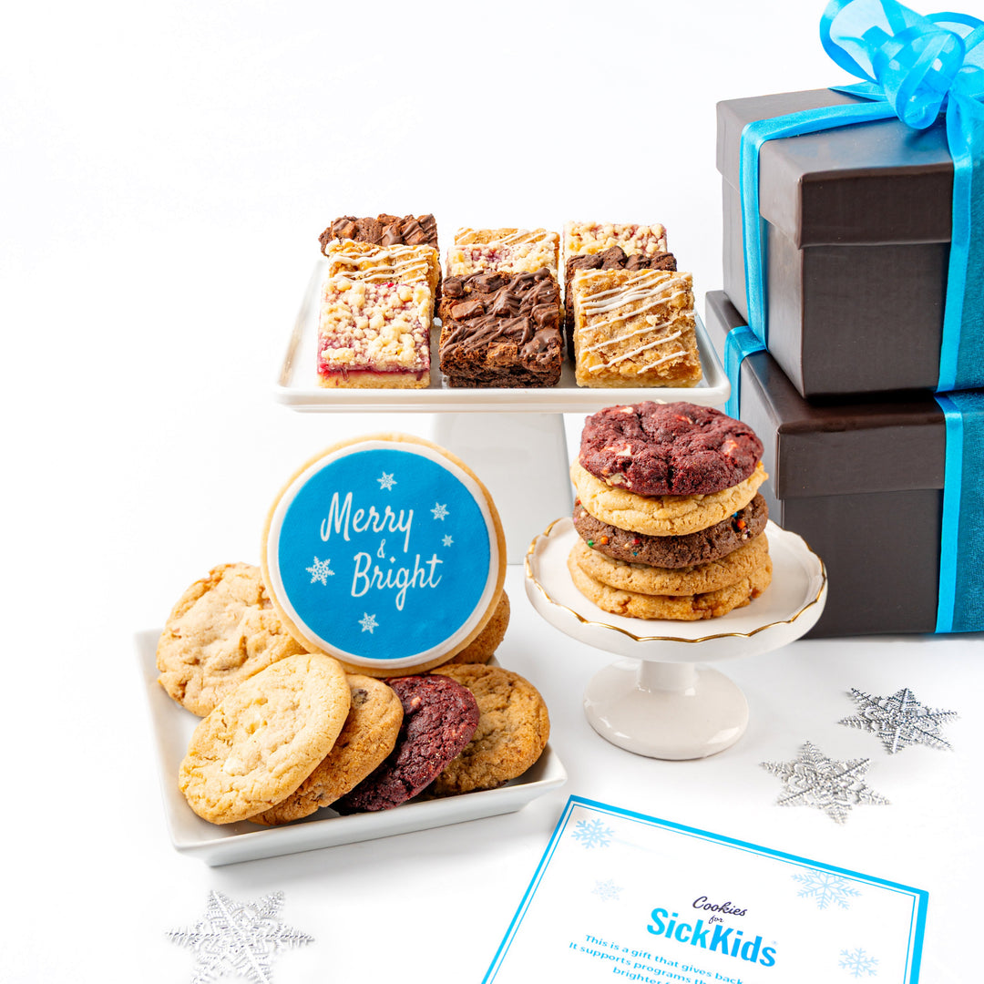 Assorted cookies, a cake stand with more cookies, and a card on a white surface with a SickKids donation