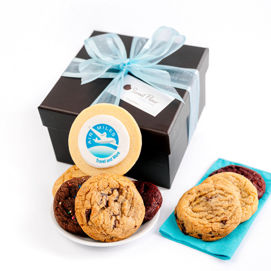 Box of assorted cookies with a blue ribbon on a white background and a custom Air Miles logo cookie