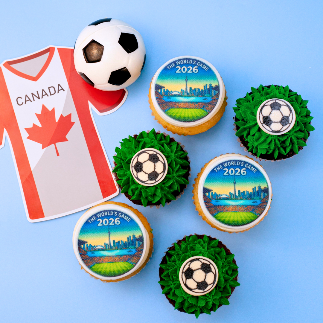 World Cup Cupcakes with soccer-themed decorations, including a soccer ball and Canada jersey, on a blue background.