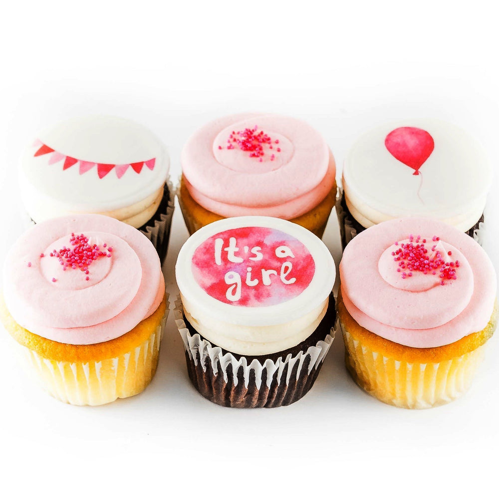 half dozen of pink It's a Girl cupcakes with balloons and banners /cupcakes near me