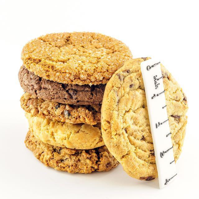 Assorted gourmet cookies stacked on top of another